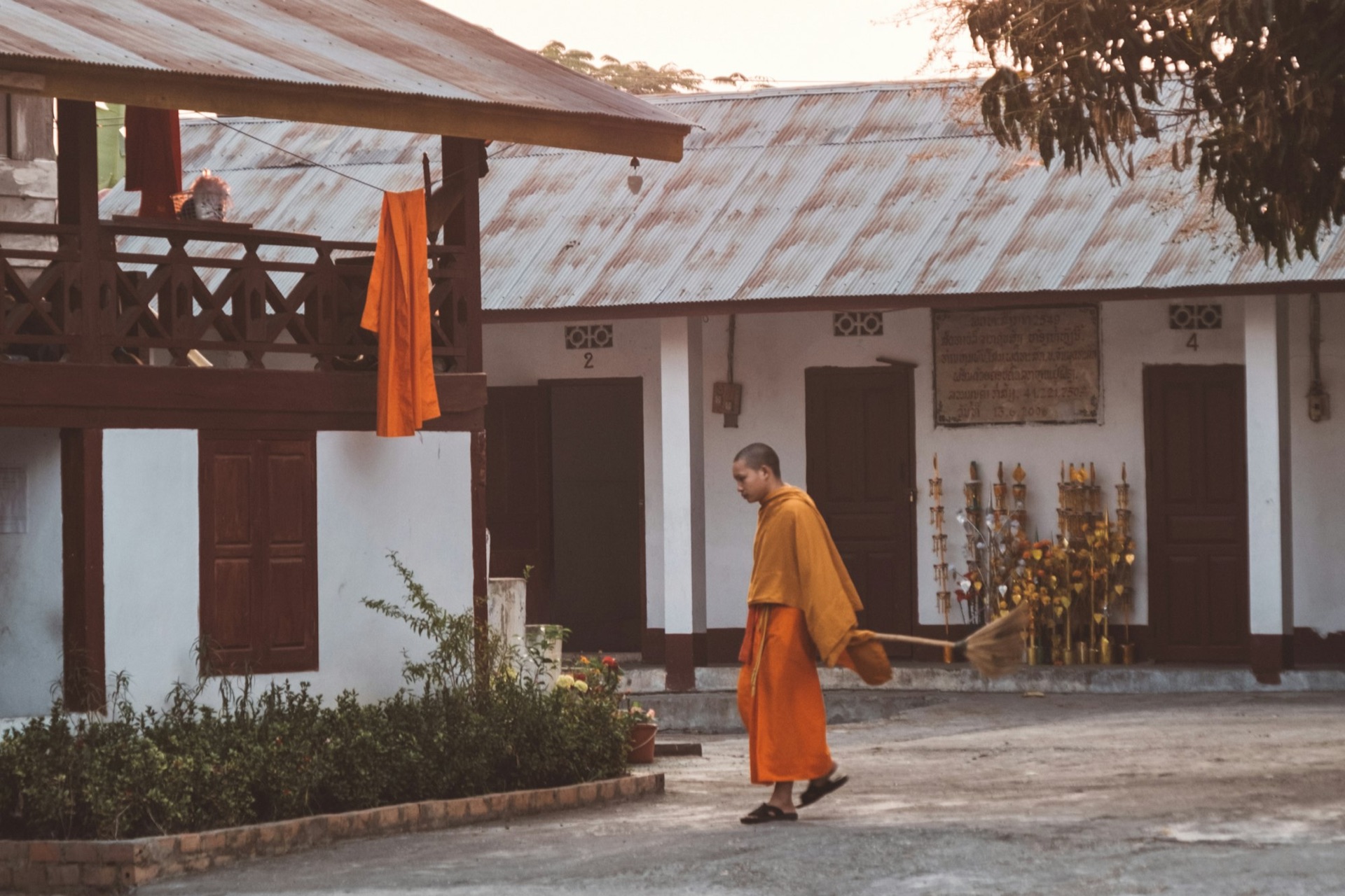 A monk passing a Franco-Lao heritage building in Luang Prabang
